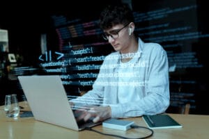 Person coding on a laptop.